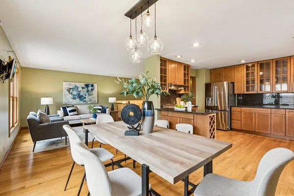 a view of a dining room with furniture a chandelier and wooden floor