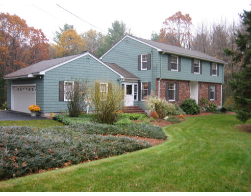 8 Regis Road Andover, MA 01810 - Photo 1 of 16 a view of a house with yard and a garden