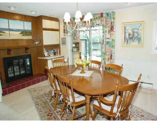 8 Regis Road Andover, MA 01810 - Photo 12 of 16 a dining room with furniture a floor to ceiling window and wooden floor