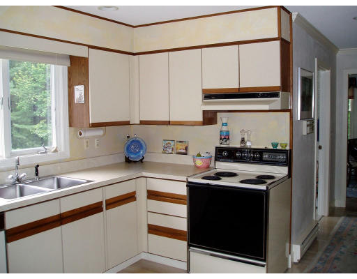 8 Regis Road Andover, MA 01810 - Photo 4 of 16 a kitchen with stainless steel appliances granite countertop a sink stove and cabinets