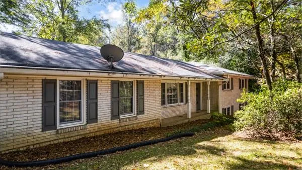 a view of house with backyard space and garden