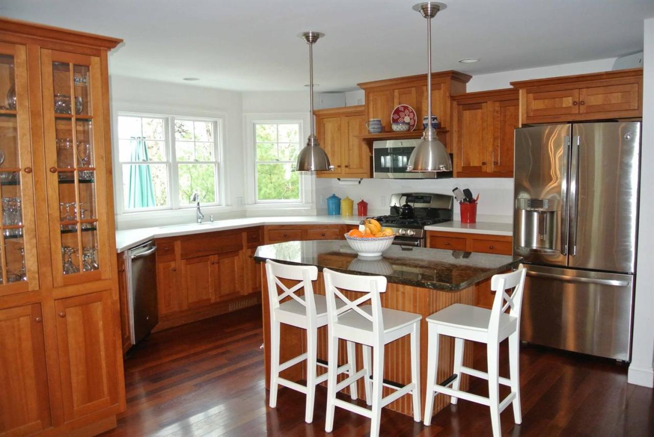15 Harbor Ridge Road Mashpee, MA 02649 - Photo 13 of 27 a kitchen with stainless steel appliances granite countertop a refrigerator a stove top oven a sink dishwasher and wooden floor