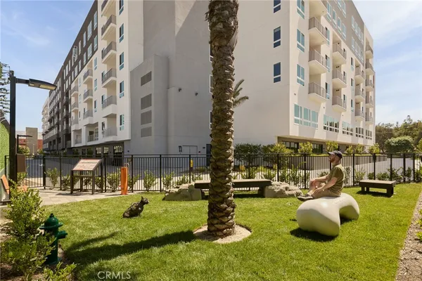 a view of a building with garden and tall buildings