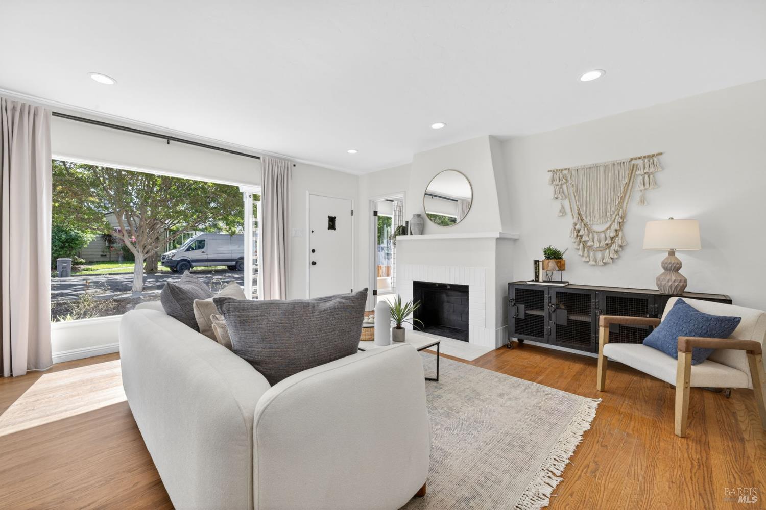 2211 Humboldt Street Santa Rosa, CA 95404 - Photo 6 of 52 a living room with furniture a large window and a fireplace