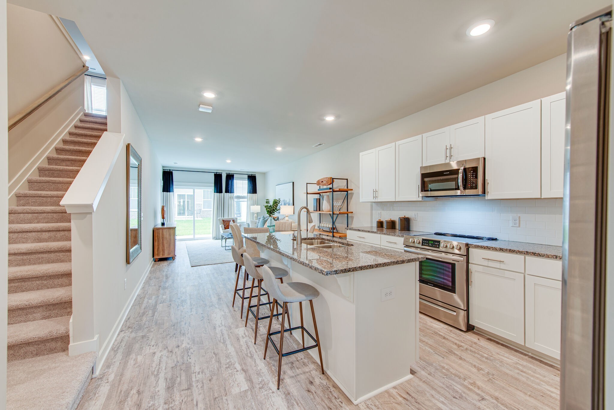 336 Casper Drive Spring Hill, TN 37174 - Photo 1 of 12 a kitchen with stainless steel appliances granite countertop a stove top oven a sink dishwasher and a refrigerator with wooden floor