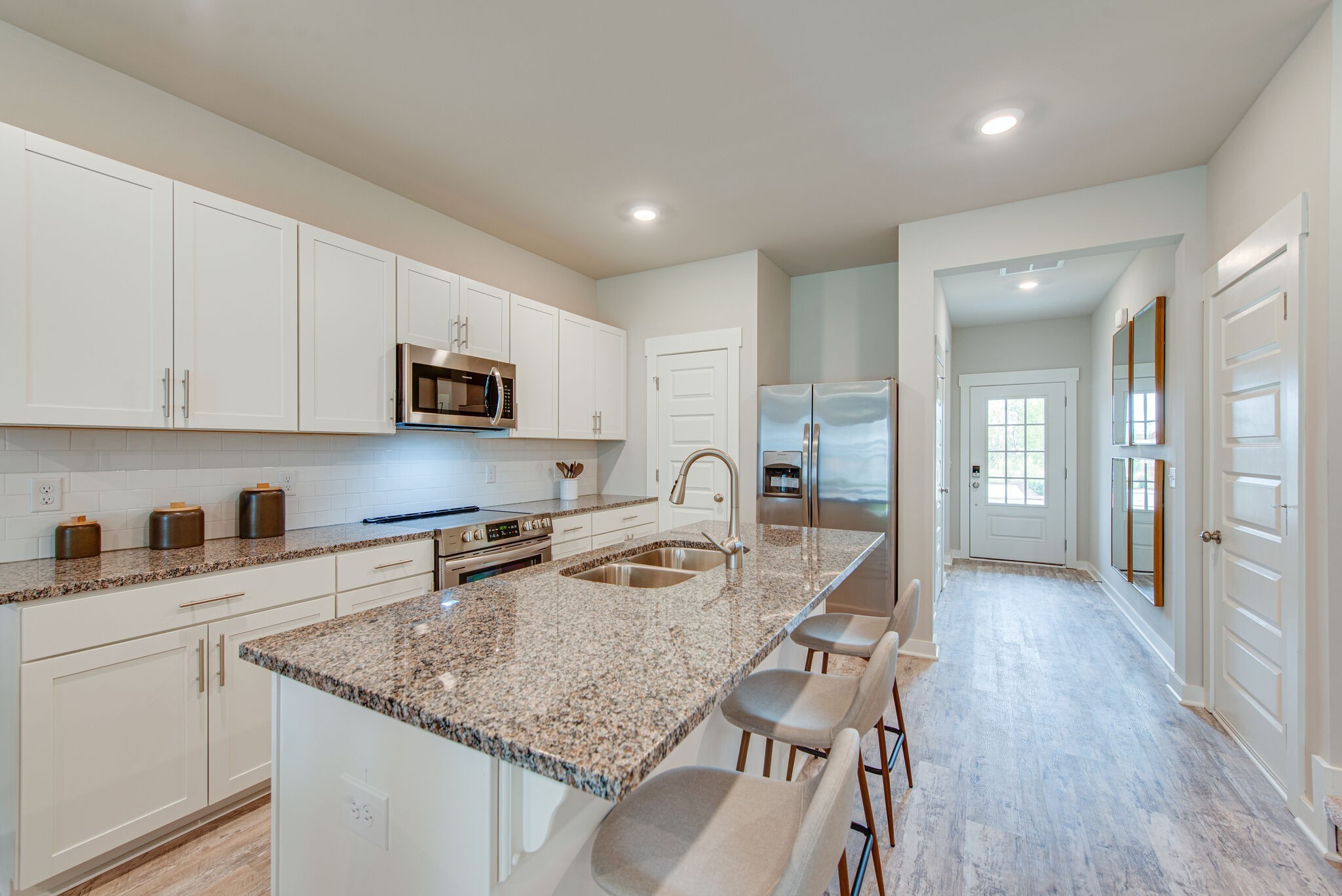 336 Casper Drive Spring Hill, TN 37174 - Photo 2 of 12 a kitchen with granite countertop a sink stove and cabinets