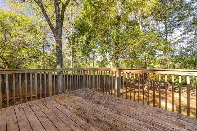 a balcony with wooden floor and city view
