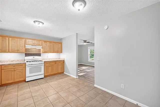 a kitchen with a stove top oven sink and cabinets
