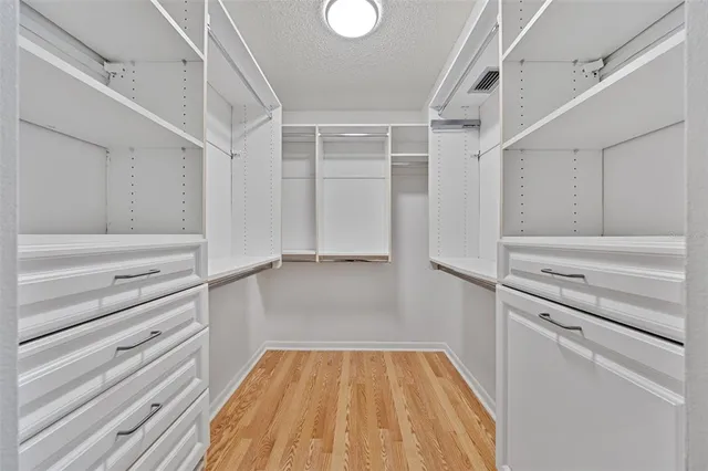 a spacious bathroom with a double vanity sink and mirror