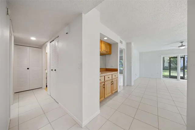 a view of a kitchen with refrigerator and window
