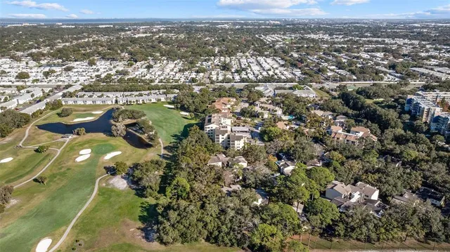 an aerial view of a house with a yard basket ball court and outdoor seating