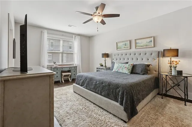 a bedroom with a bed window and a table