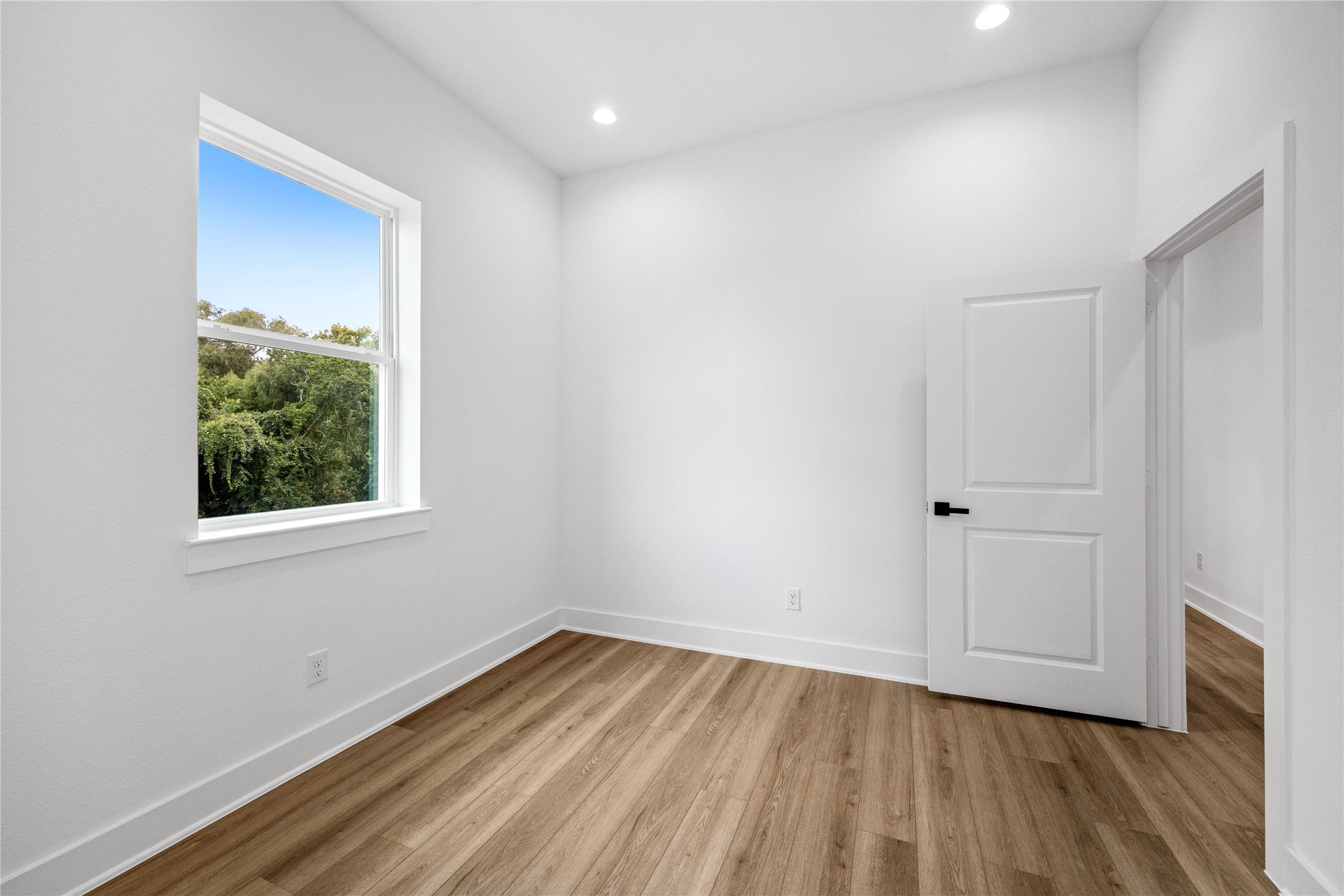 7901 Cora Street, Unit B Houston, TX 77088 - Photo 17 of 20 a view of a room with wooden floor and window