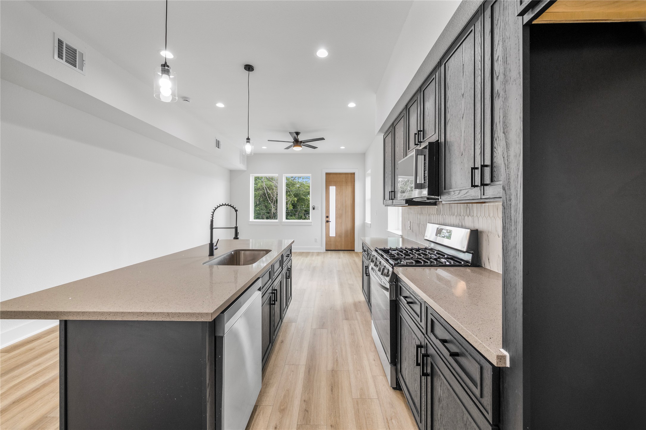 7901 Cora Street, Unit B Houston, TX 77088 - Photo 3 of 20 a kitchen with stainless steel appliances granite countertop a sink stove and refrigerator