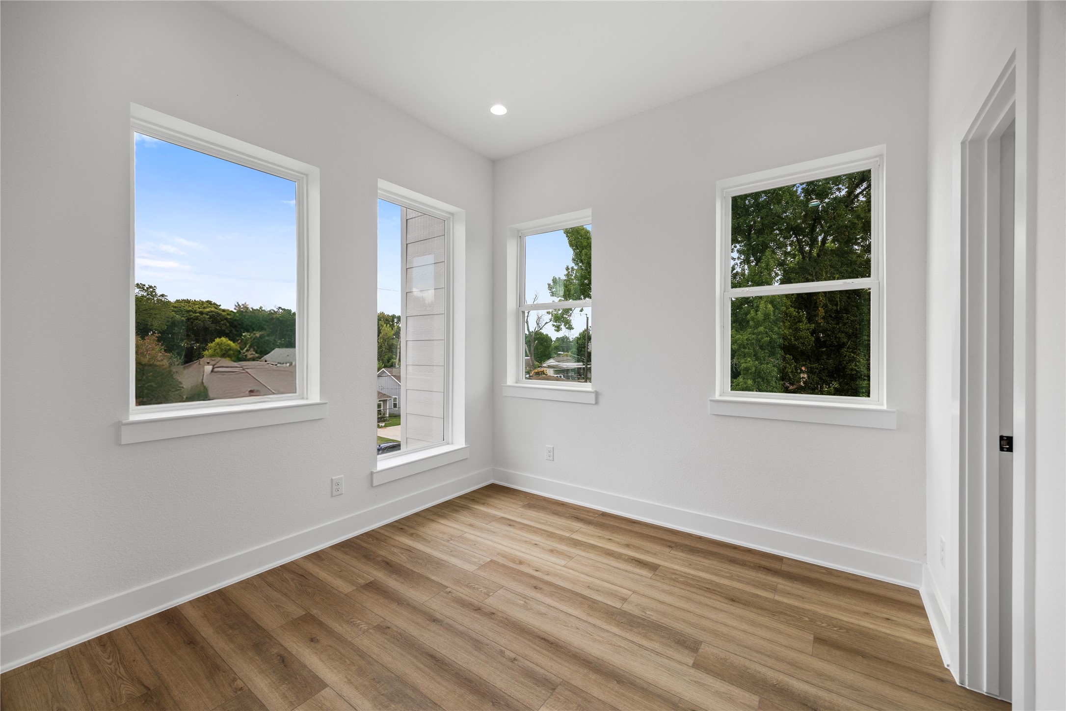 7901 Cora Street, Unit B Houston, TX 77088 - Photo 6 of 20 a view of an empty room with wooden floor and a window