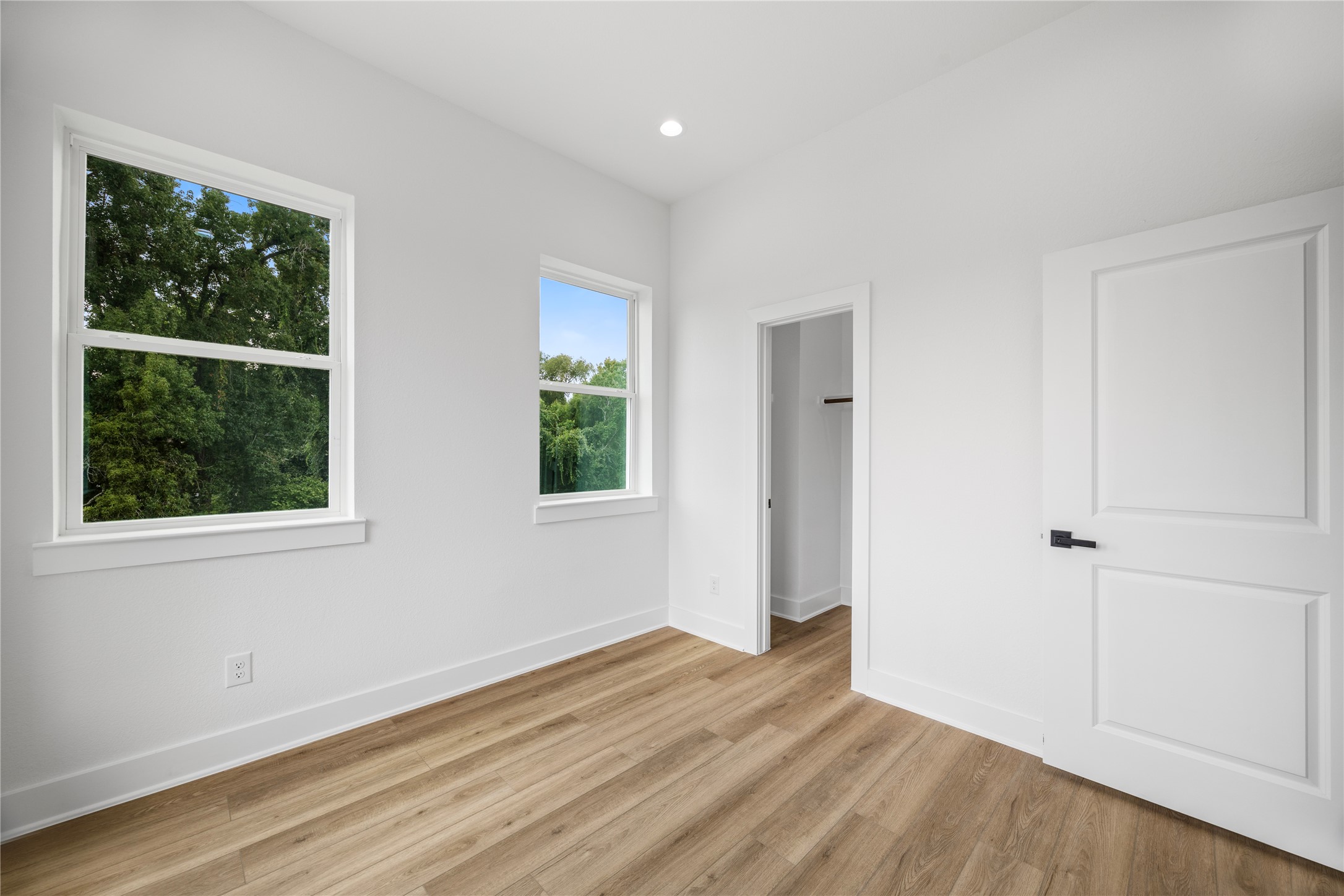 7901 Cora Street, Unit B Houston, TX 77088 - Photo 7 of 20 a view of an empty room with wooden floor and a window
