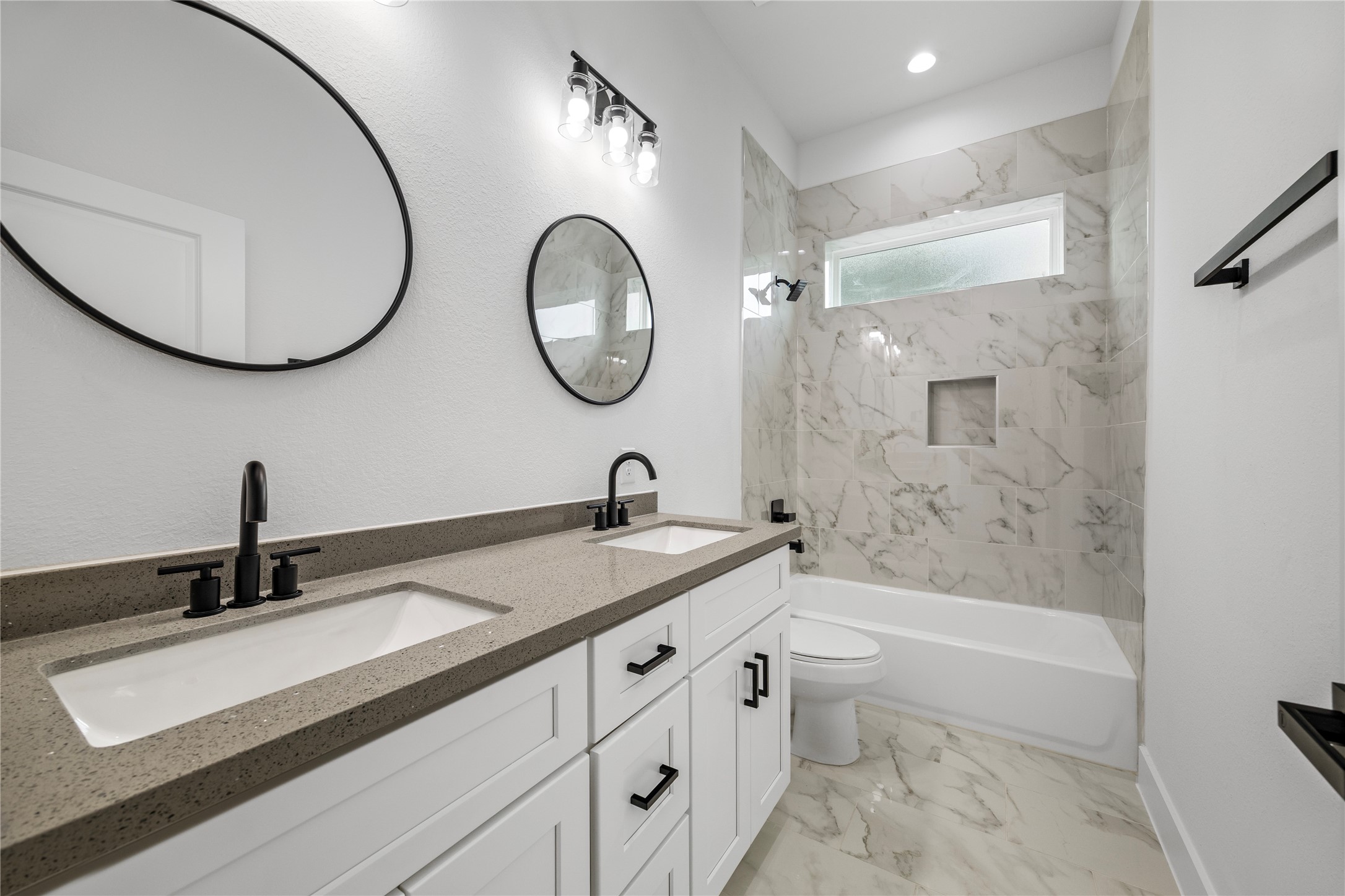 7901 Cora Street, Unit B Houston, TX 77088 - Photo 9 of 20 a bathroom with a double vanity sink and a mirror