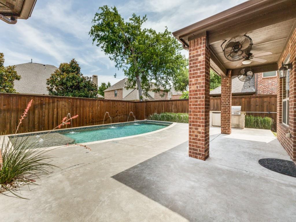 916 Redbird Lane Allen, TX 75013 - Photo 2 of 28 Spacious deck and covered porch along with a sparkling pool out back.