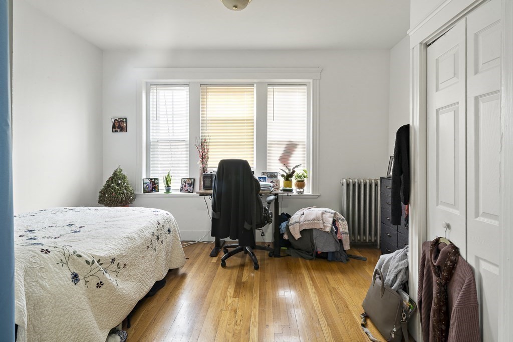 65 Lanark Road, Unit 7 Boston, MA 02135 - Photo 8 of 18 a bedroom with furniture and a window