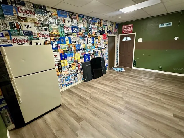 a view of a room with wooden floor and windows