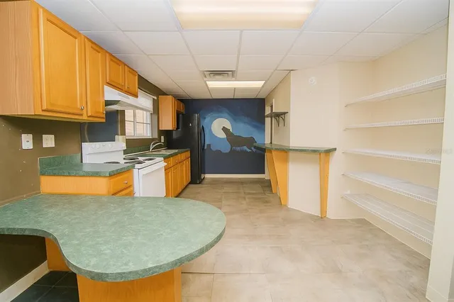 a kitchen with stainless steel appliances granite countertop a stove top oven a sink dishwasher and cabinets with wooden floor