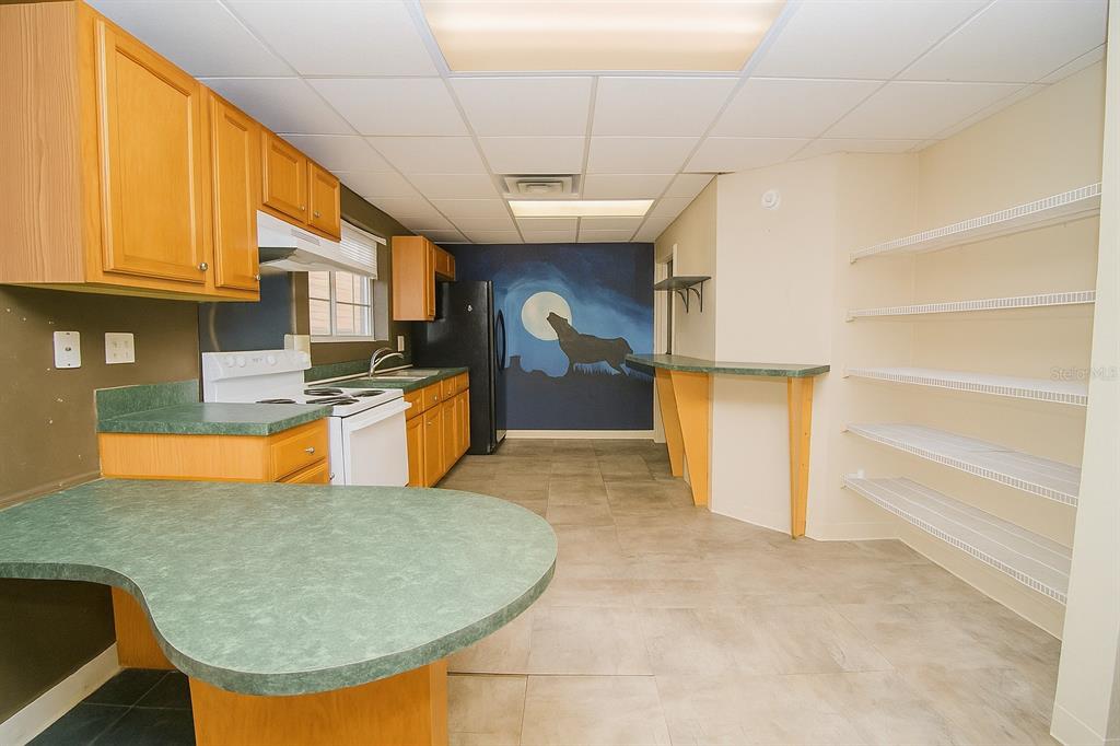 905 Southwest 8th Avenue Gainesville, FL 32601 - Photo 19 of 31 a kitchen with stainless steel appliances granite countertop a sink a stove and a refrigerator