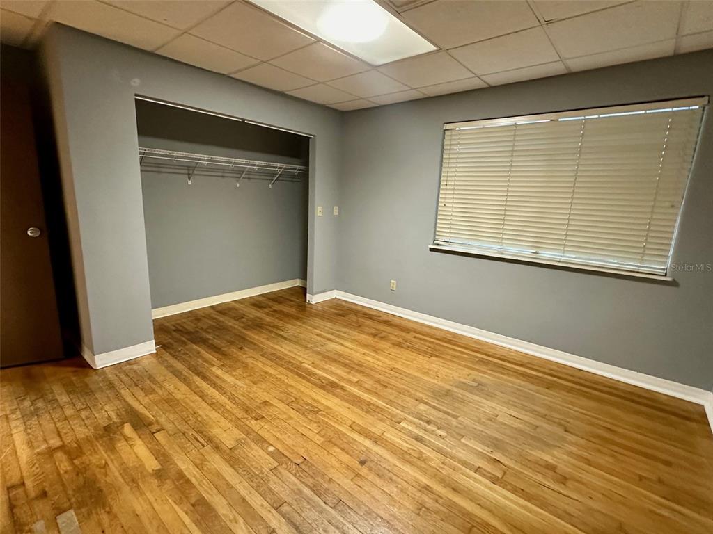 905 Southwest 8th Avenue Gainesville, FL 32601 - Photo 26 of 31 a view of an empty room with wooden floor and a window