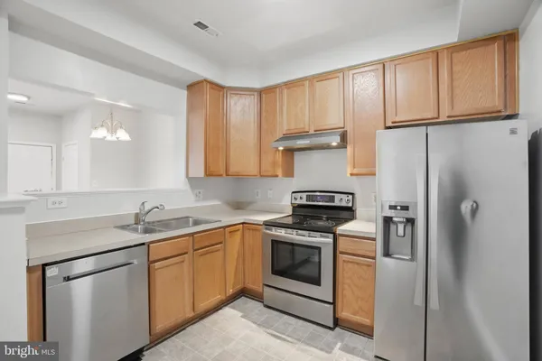 a kitchen with a stove and a refrigerator