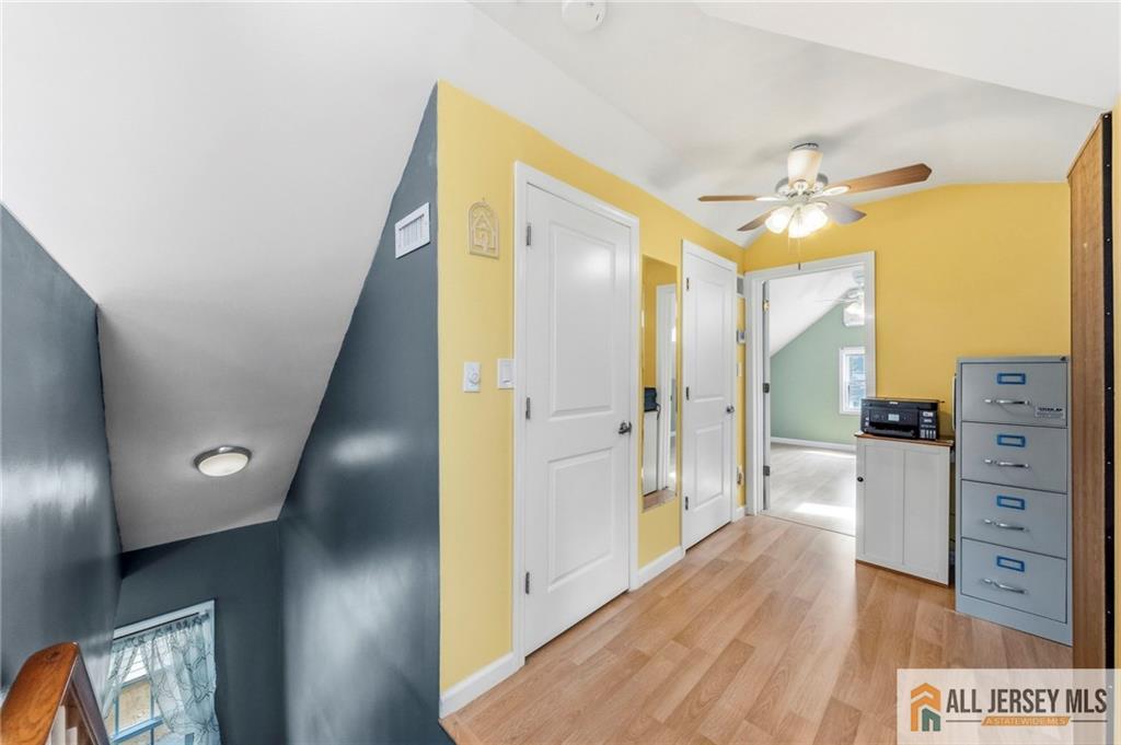 50 3rd Street Fords, NJ 08863 - Photo 22 of 36 a view of a hallway with wooden floor and cabinet with a flat screen tv