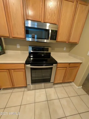 a kitchen with granite countertop a stove and a cabinets