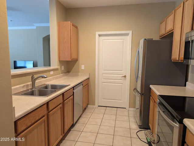 a kitchen with a sink and a refrigerator