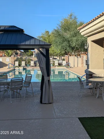 a backyard of a house with table and chairs
