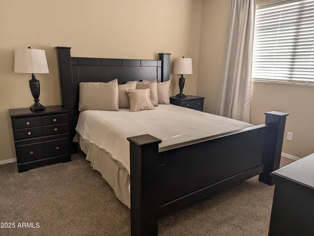 a bedroom with a bed and a night stand