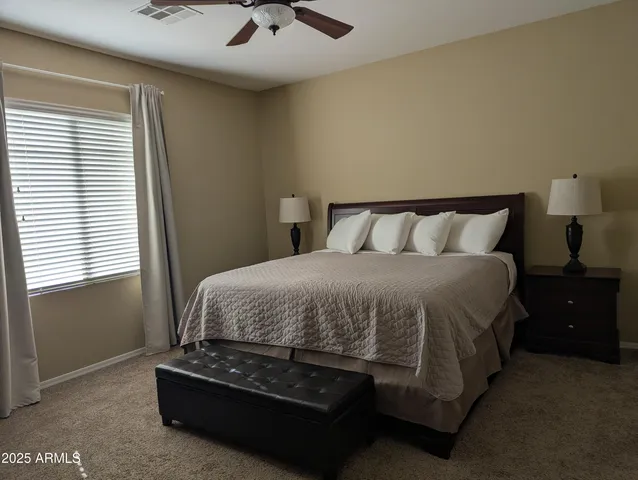 a bedroom with a bed and window