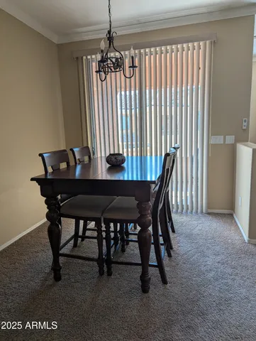 a view of a dining room with furniture and a chandelier