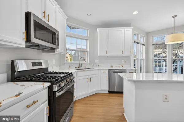 a kitchen with stainless steel appliances granite countertop a stove and a sink