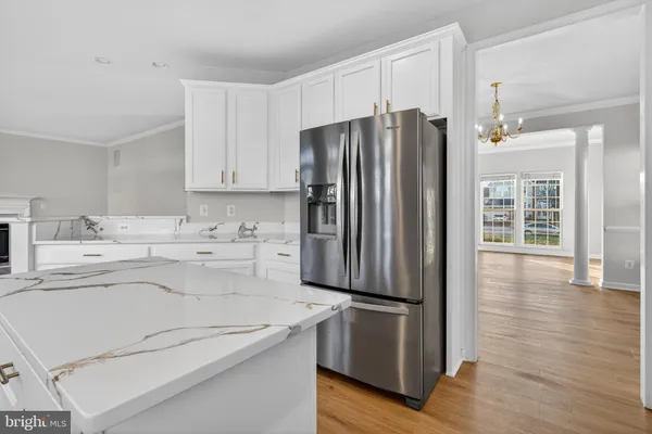 a kitchen with granite countertop a refrigerator and a sink