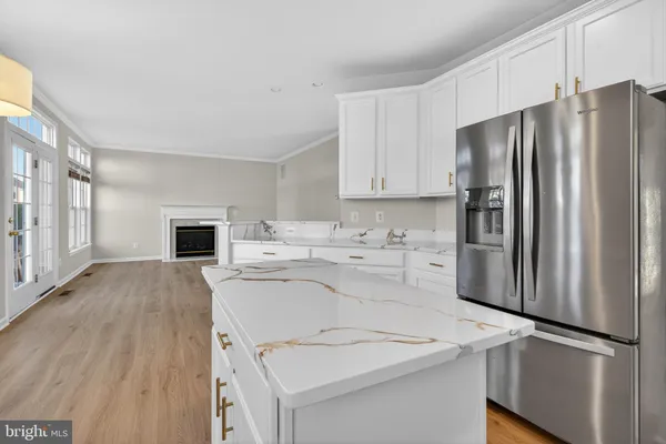 a kitchen with kitchen island a refrigerator sink and stove