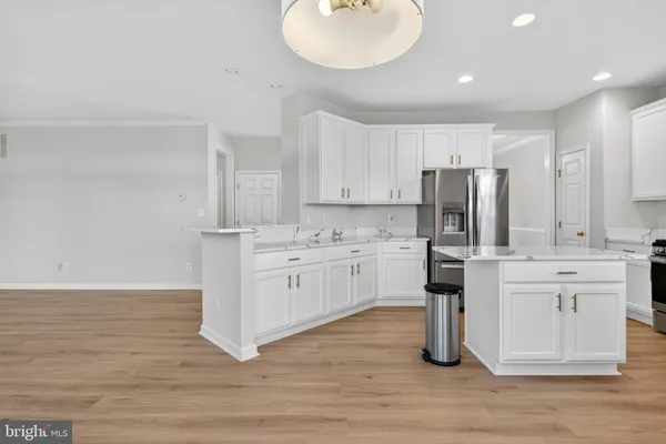 a kitchen with white cabinets stainless steel appliances and sink