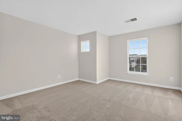 a view of an empty room and closet area