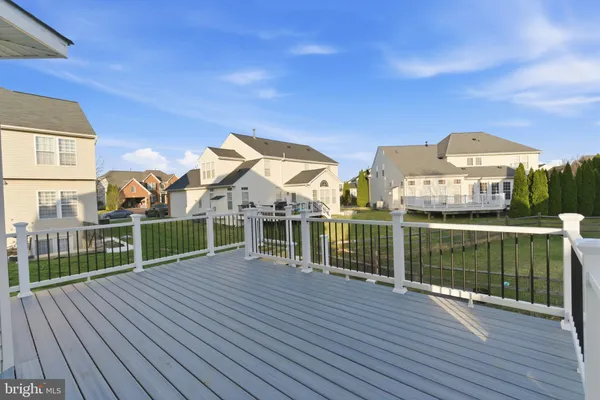 a view of a house with backyard and deck