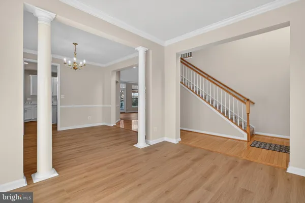 a view of a hallway with wooden floor and staircase