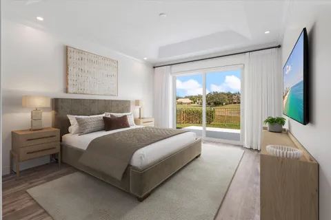 a bedroom with a large bed and a large window