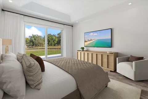 a bedroom with a bed and a large window