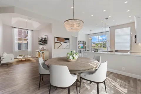 a view of a dining room with furniture large window and wooden floor