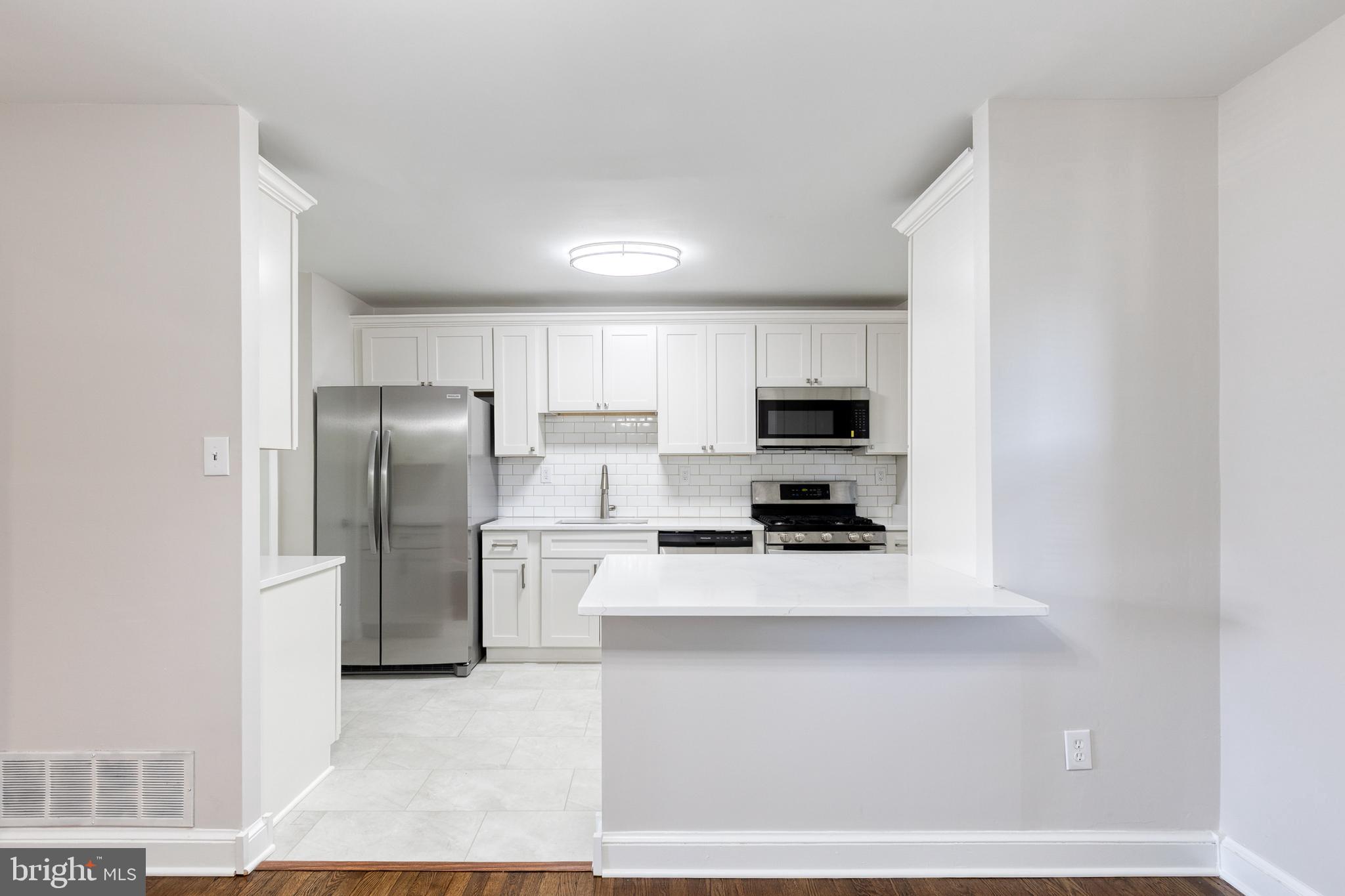 5649 Utrecht Road Baltimore, MD 21206 - Photo 19 of 42 a kitchen with stainless steel appliances a refrigerator sink and microwave