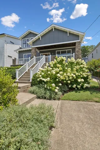 a view of a porch with furniture and floor to ceiling window