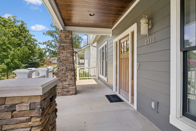 a view of a kitchen with kitchen island a sink wooden floor and a refrigerator