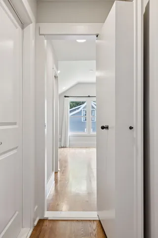 an empty room with cabinet and windows