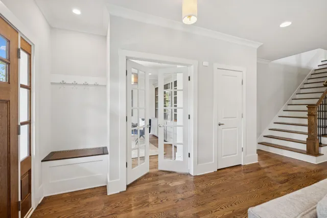 a living room with furniture a fireplace and a large mirror